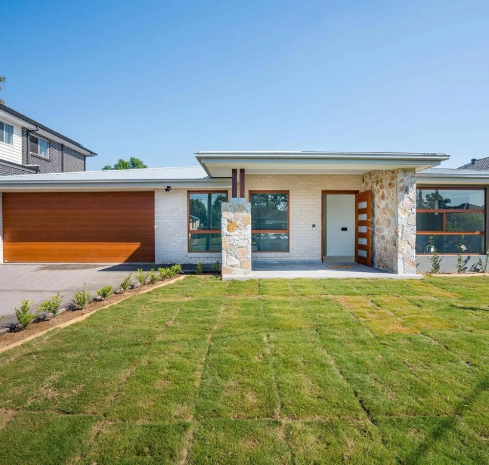 Single-storey accessible home with a front lawn and driveway